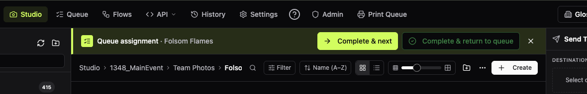 The Queue assignment banner at the top of a team's folder in Studio, with Complete & next and Complete & return to queue buttons